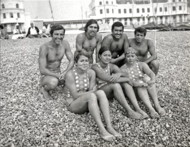 The Egyptian Channel Swimming Team sat on the beach with the Harbour Board Buildings behind them